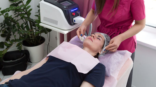 High angle view of doctor examining patient in hospital