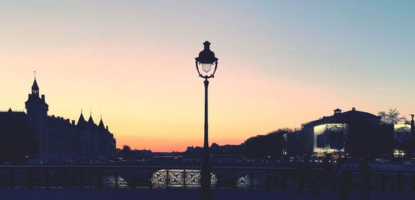 Silhouette buildings against sky during sunset