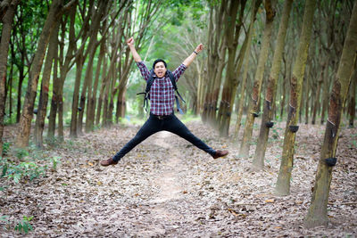 Full length of man jumping in forest