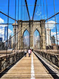 People walking on suspension bridge