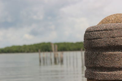Close-up of stone stack against calm lake