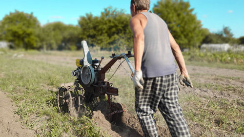 Rear view of man standing on field