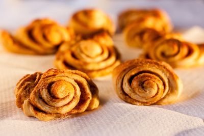 Close-up of fresh baked cinnamon buns on tissue paper