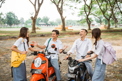 Group of friends sitting on street