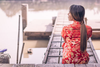 Rear view of woman with red umbrella