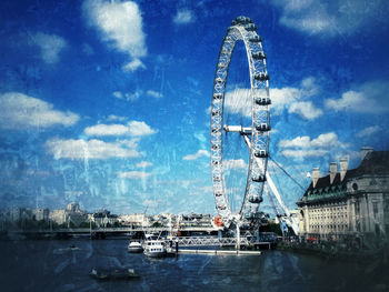 Ferris wheel against cloudy sky