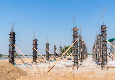 Concrete pillars form work of new building in construction site with a blue sky.