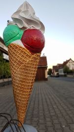 Close-up of ice cream on footpath