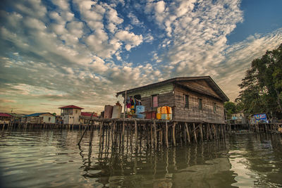 Stilt houses on sea during dusk