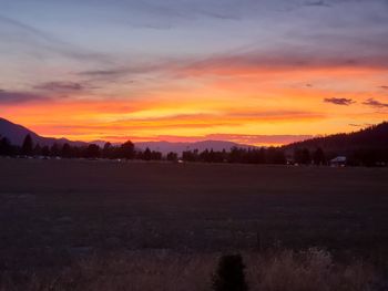 Scenic view of field against sky during sunset