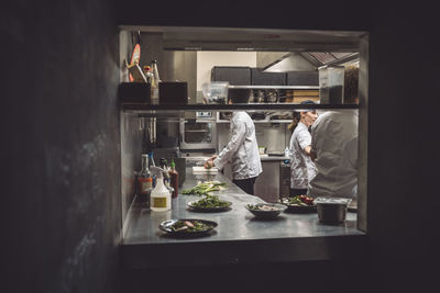 Male and female chefs working in restaurant