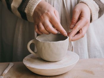 Midsection of woman holding coffee