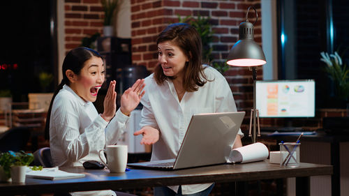 Young woman using laptop at office