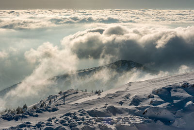 Scenic view of snow covered mountains against sky