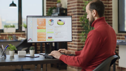 Businessman using desktop pc at office