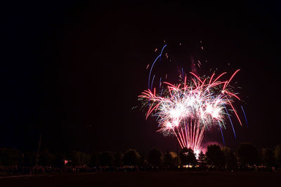 Low angle view of firework display at night