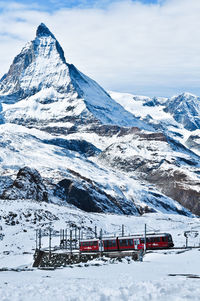 Train against snowcapped mountain