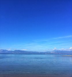 Scenic view of sea against blue sky