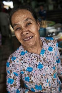 Close-up portrait of senior woman standing outdoors at night