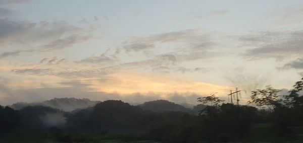 Scenic view of trees against sky during sunset