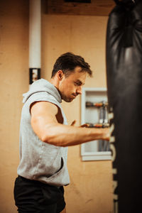 Side view of man looking at camera