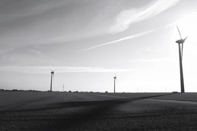 Road amidst field against sky