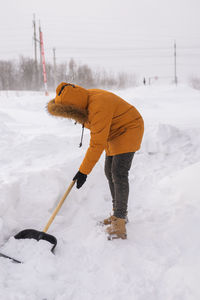 Low section of man skiing on snow