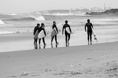 People on beach against sea