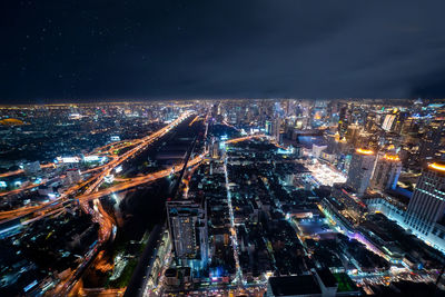 High angle view of illuminated city buildings at night
