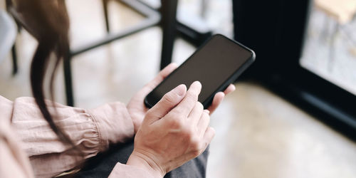 Midsection of man using mobile phone