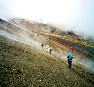 People on mountain road against sky