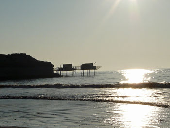Scenic view of sea against clear sky during sunset