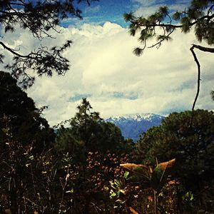 Scenic view of mountains against cloudy sky