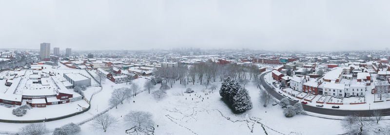 High angle view of snow covered buildings in city