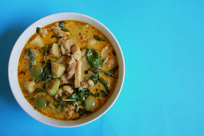 Copy space thai food chicken green curry on blue background