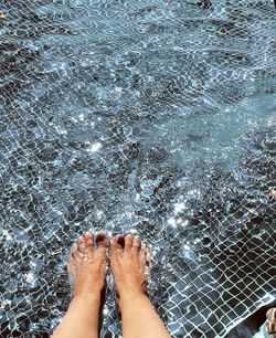 Low section of woman in swimming pool