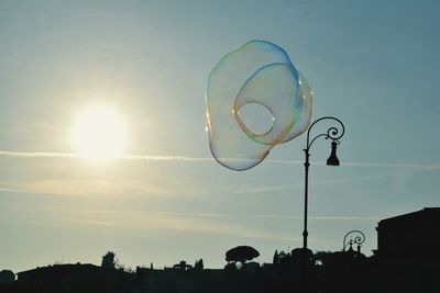 Low angle view of bubbles against sky at sunset