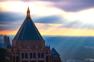 Low angle view of tower against sky during sunset