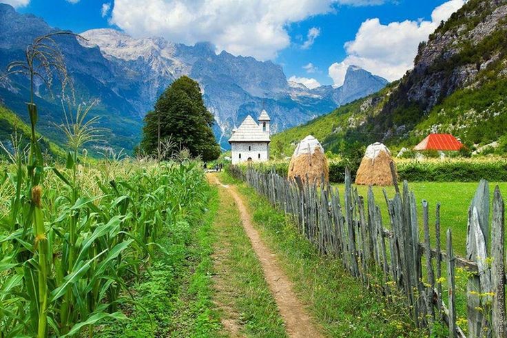 mountain, sky, landscape, rural scene, built structure, mountain range, grass, architecture, tranquility, building exterior, tranquil scene, house, the way forward, nature, agriculture, beauty in nature, field, scenics, fence, farm