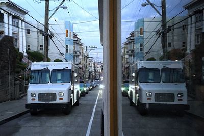 Cars on road amidst buildings in city