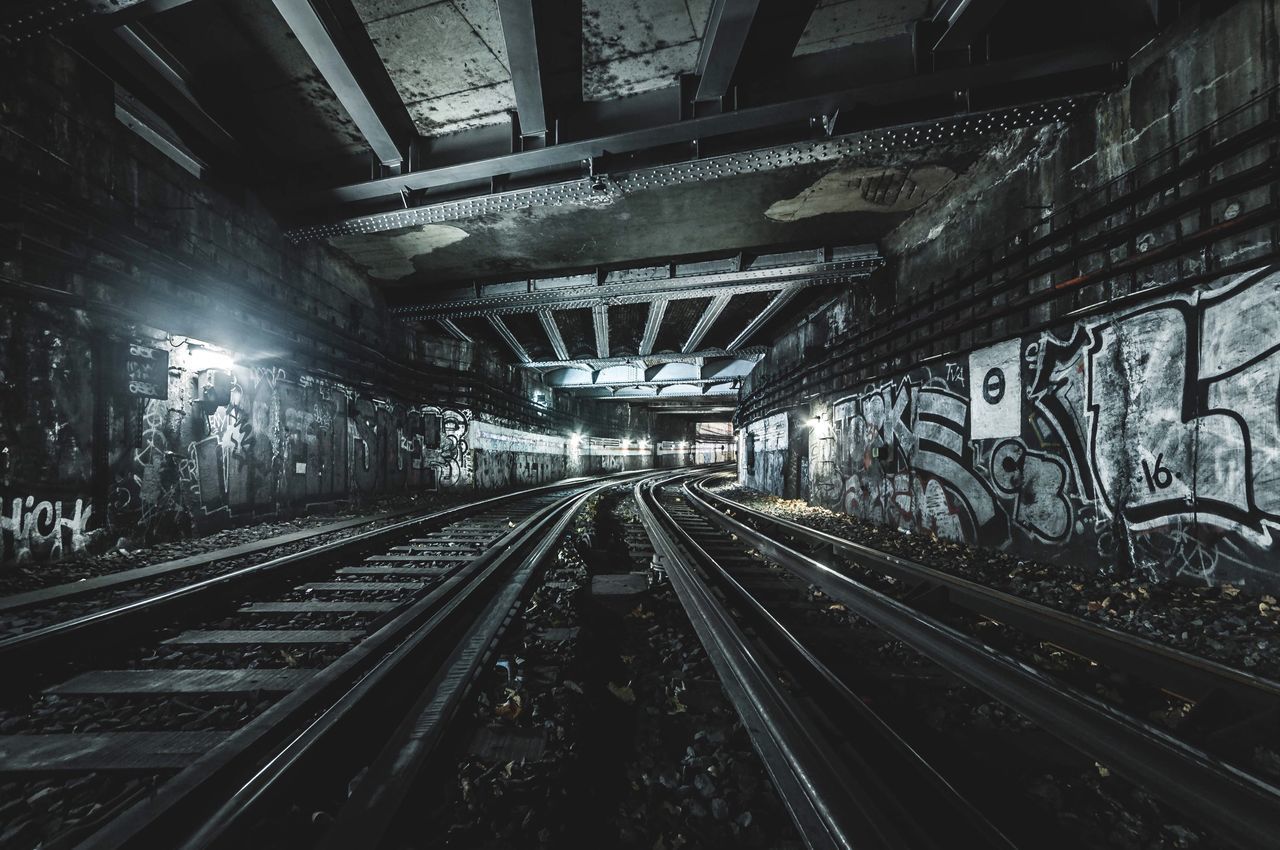 transportation, track, railroad track, rail transportation, architecture, direction, mode of transportation, the way forward, no people, built structure, diminishing perspective, public transportation, illuminated, vanishing point, lighting equipment, indoors, travel, day, city, long