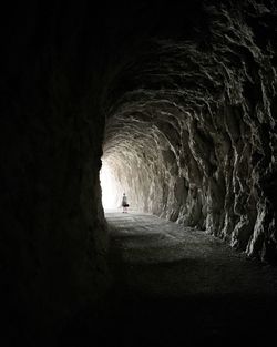 Woman standing in tunnel