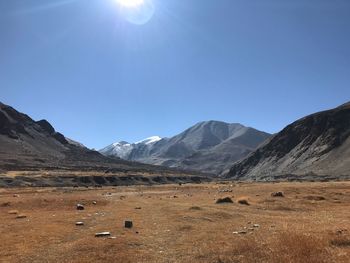 View of mountain range against blue sky