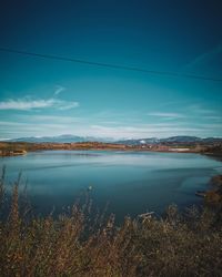 Scenic view of lake against blue sky