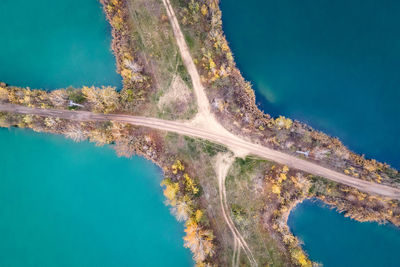 High angle view of lakes decided by road and trees