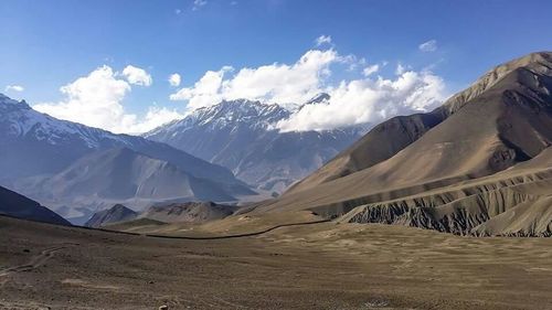 Scenic view of mountains against cloudy sky