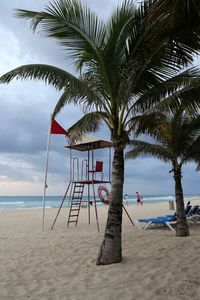 Lifeguard hut on beach against sky