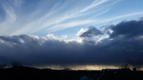 Scenic view of mountains against cloudy sky