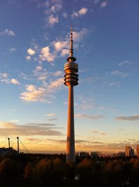 Communications tower against cloudy sky