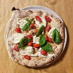Close-up of pizza over white background